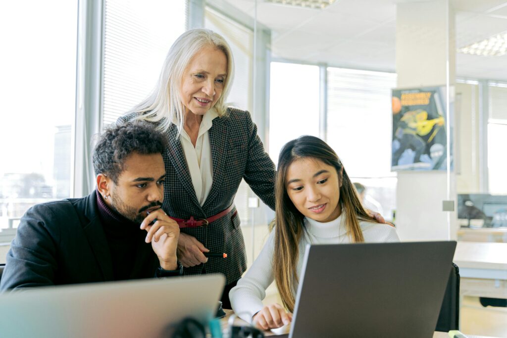 Leadership development trainer looking over two trainees
